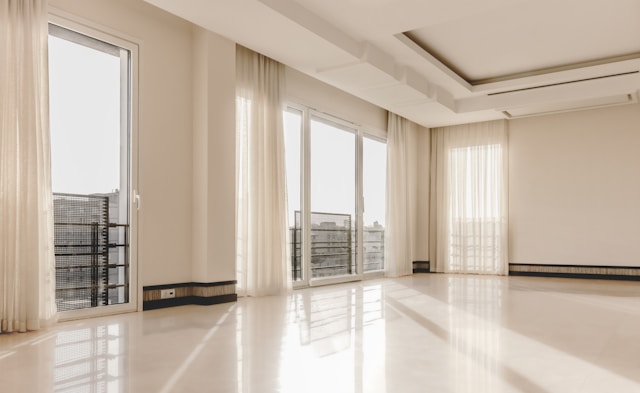 A large, empty room with many windows